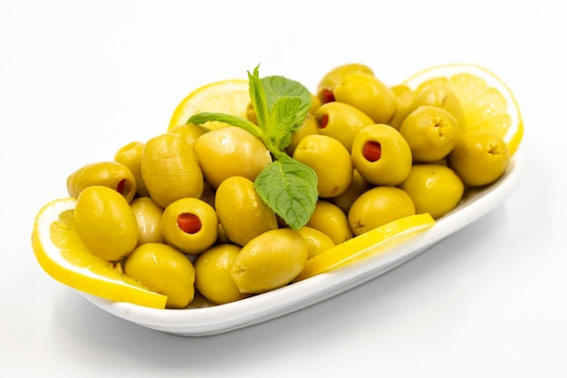 Green olives stuffed with peppers Natural peppered olives on isolated white background Healthy food close up