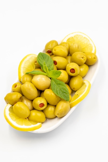 Green olives stuffed with peppers Natural peppered olives on isolated white background Healthy food close up