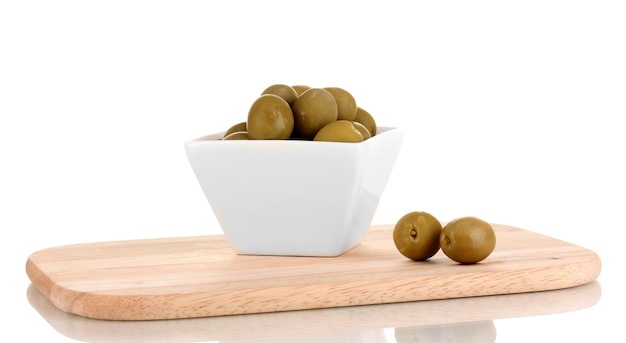 Green olives in white bowl on board isolated on white