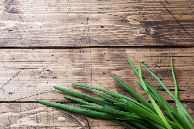 Green onions or shallots on a wooden background