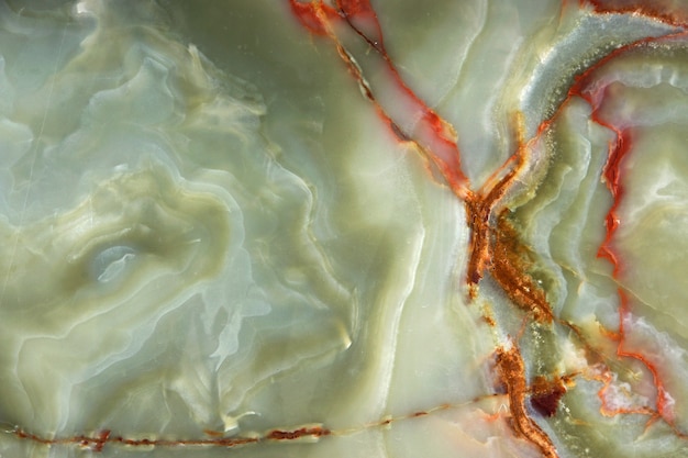 Green onyx with red veins, the surface of natural stone.