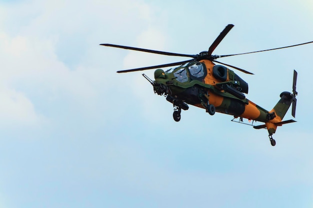 A green and orange attack helicopter