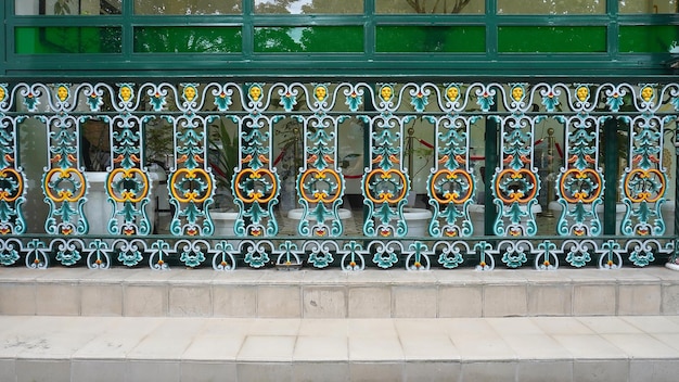 A green and orange decorative railing with the word " love " on it.