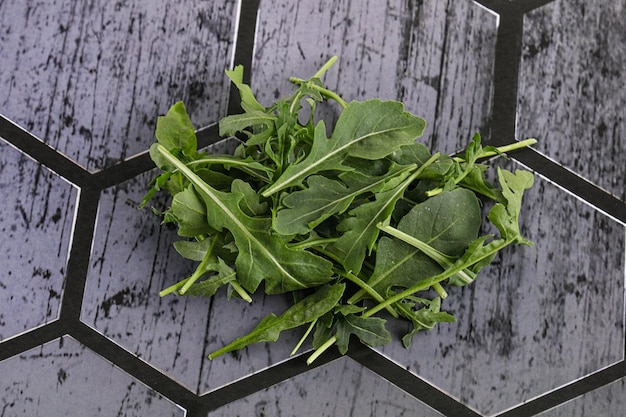 Green organic Arugula heap over background