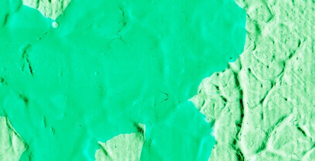 Green paint on a wall with a white background