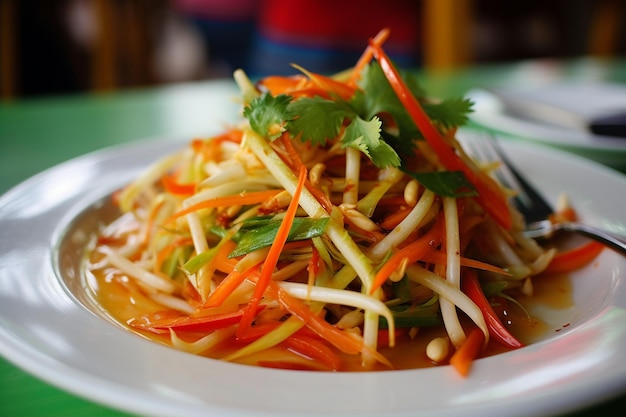 Green papaya salad som tam thai on wooden tablexa