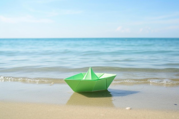 Photo a green paper boat on the beach with a green paper boat on the water