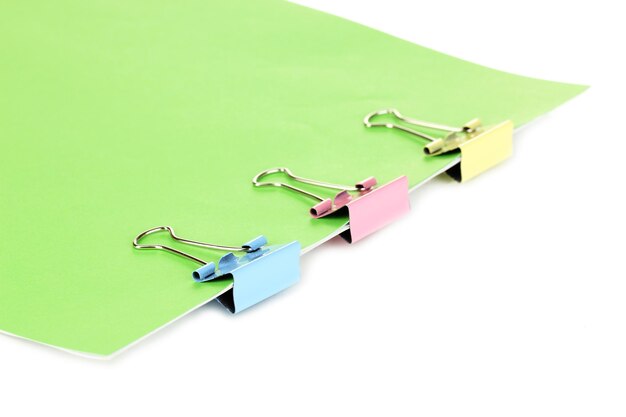 Green paper with binder clips close up