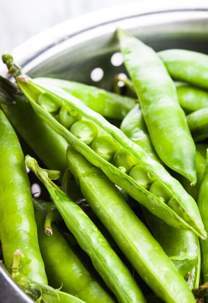 Green pea in the colander, close up