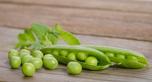 Green pea pod on the wooden table