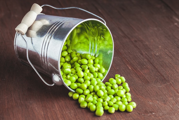 Green pea scattered on the wooden table