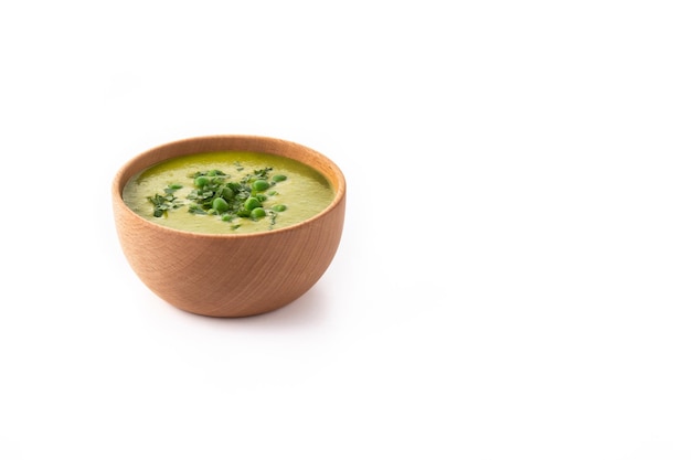 Green pea soup in a bowl isolated on white background