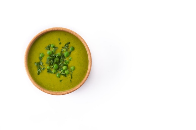 Green pea soup in a bowl isolated on white background