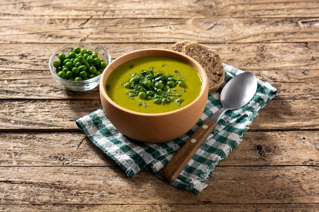 Green pea soup in a bowl isolated on white background