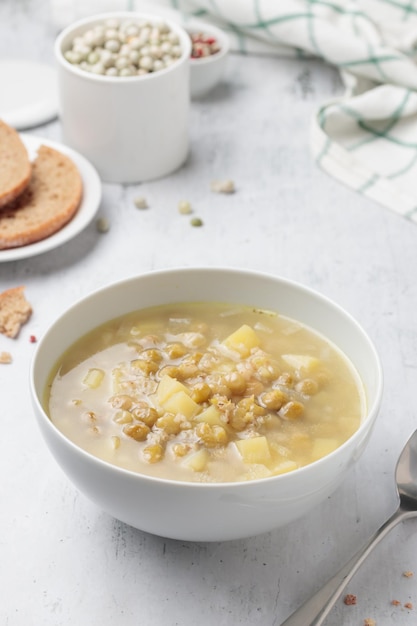 Green pea soup in a large white bowl