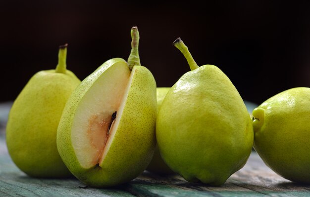 Green pears on a rustic wooden