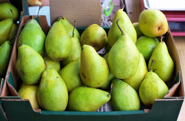 Green pears for sale on a market