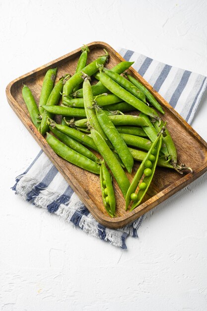 Green peas Freshly harvested on white stone table background