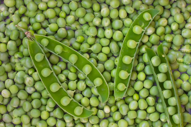 Green peas and pea pod close up. Top view. Food background
