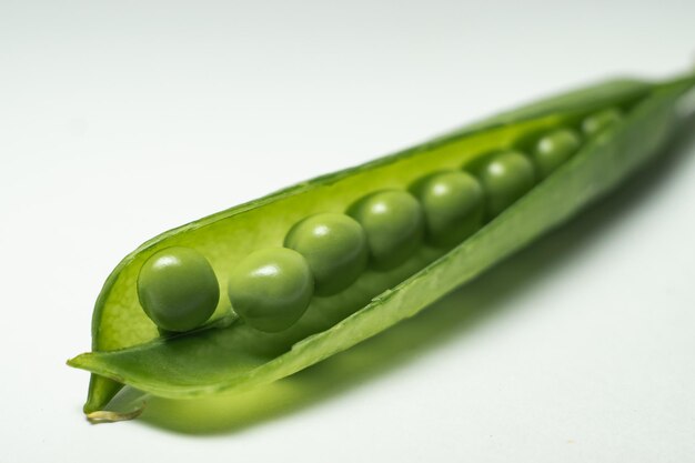 green peas in pod on white