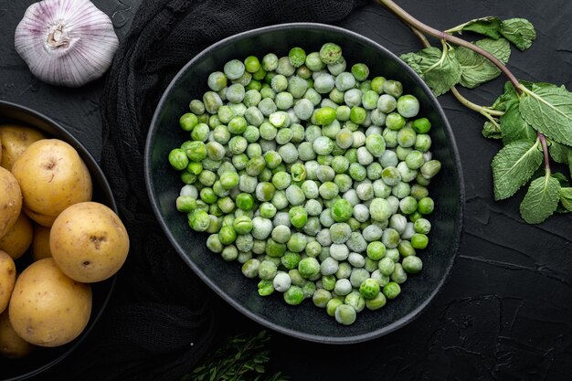 Green peas set, flat lay, on black table