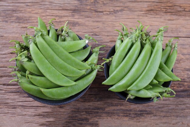 Green peas on wooden table