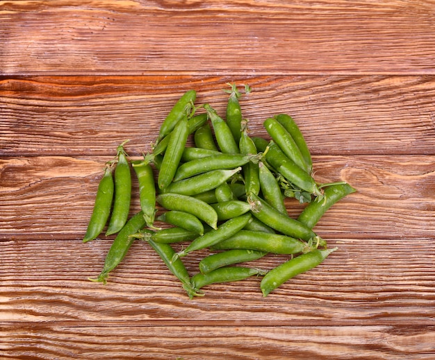 Green peas on wooden wall.top view