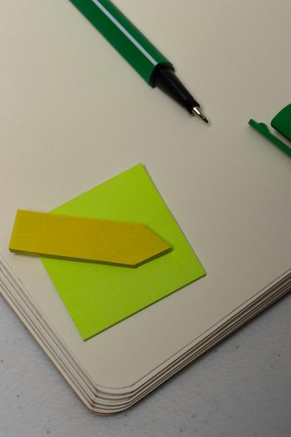 Green pencil on dotted notebook to make bullet journal