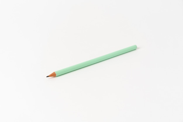 Green pencil on white background