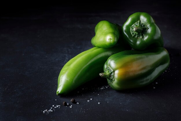 Green pepper on black surface