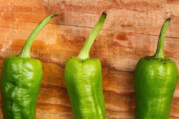 Green peppers on a wooden table