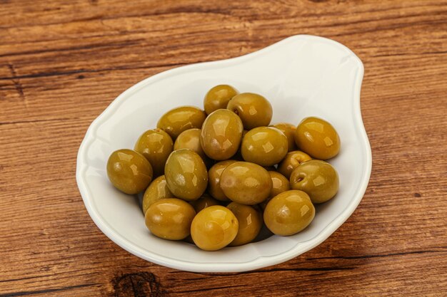 Green pickled olives in the bowl