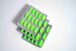 Photo green pills on a white background