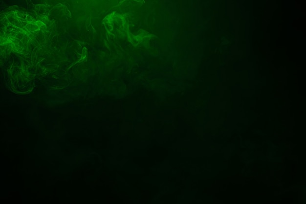 Green and pink steam on a black background. Copy space.