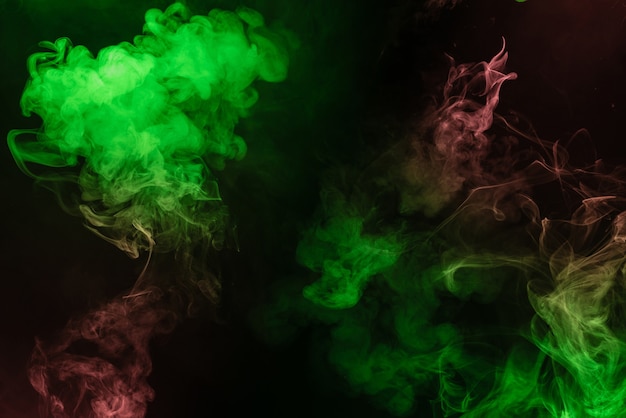 Green and pink steam on a black background. Copy space.