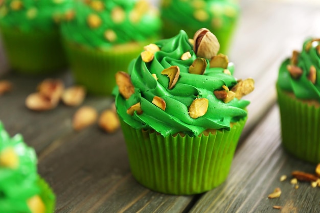 Green pistachio cupcakes on wooden background