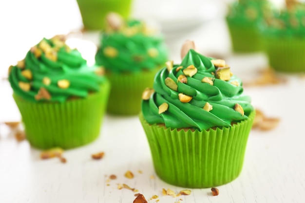 Green pistachio cupcakes on wooden table