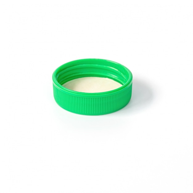 Green plastic bottle cap isolated on white.