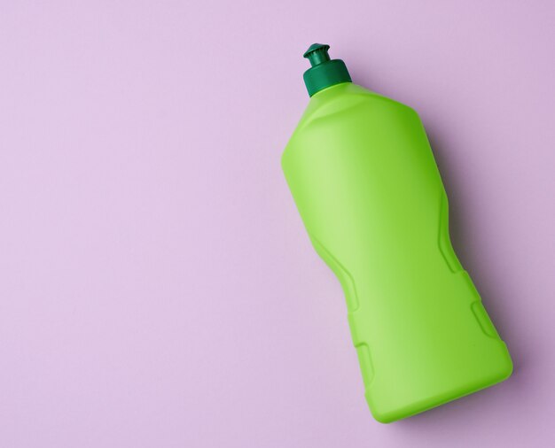 Green plastic bottle with detergent