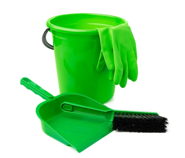 Green plastic bucket and a scoop isolated on white background