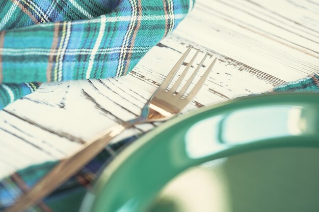 Green plastic kitchenware on a table close up