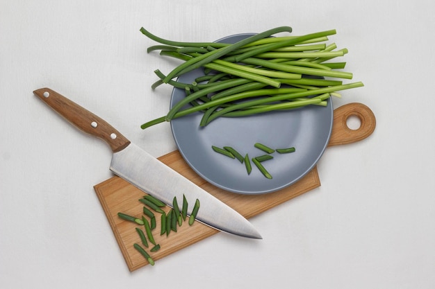 Green pods of garlic on gray plate