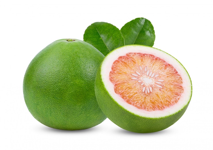 Photo green pomelo citrus fruit with leaves on white table. 