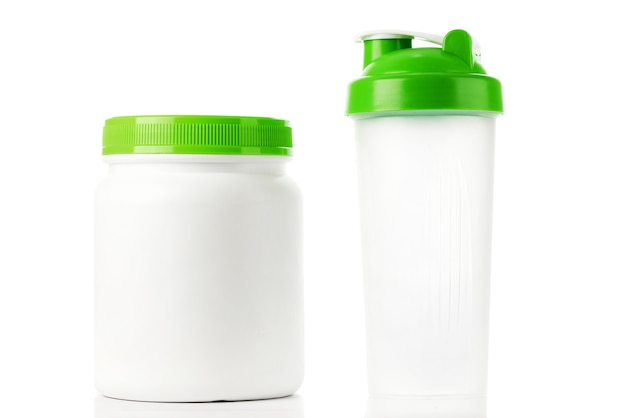 Photo green protein shaker and jar isolated on white