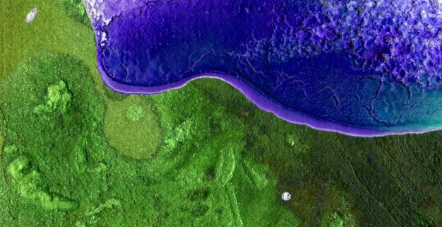 A green and purple painting of a purple and green body of water.