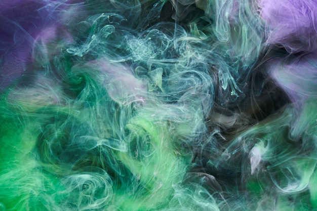 Green purple smoke abstract background acrylic paint underwater explosion