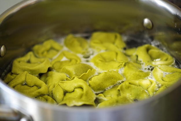 Green ravioli boiled in a pan