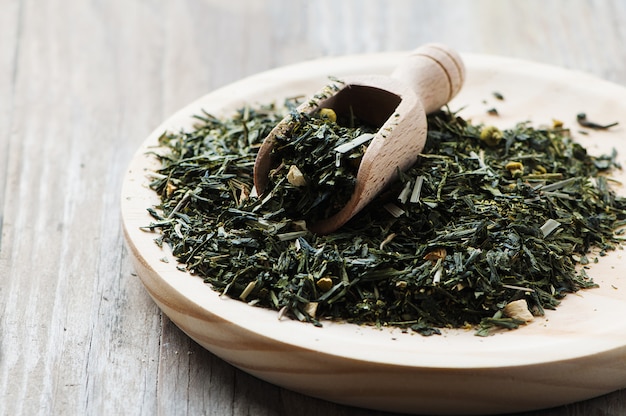 Green raw tea on the wooden table