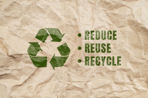 Green recycling symbol on brown creased paper background from a paper packaging ecofriendly