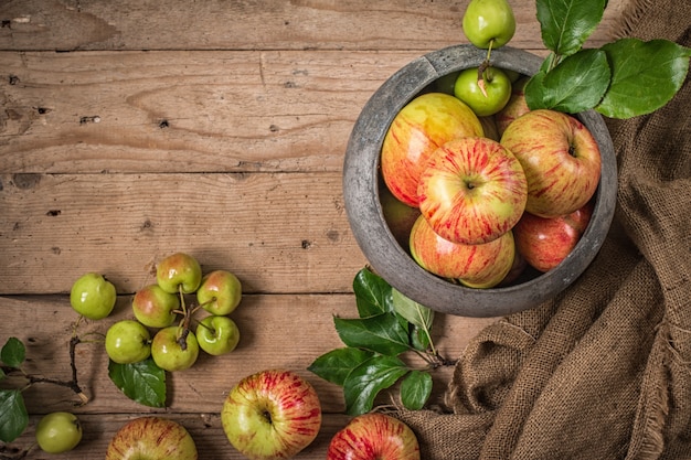 Green and red apples on rustic  table. Flat lay